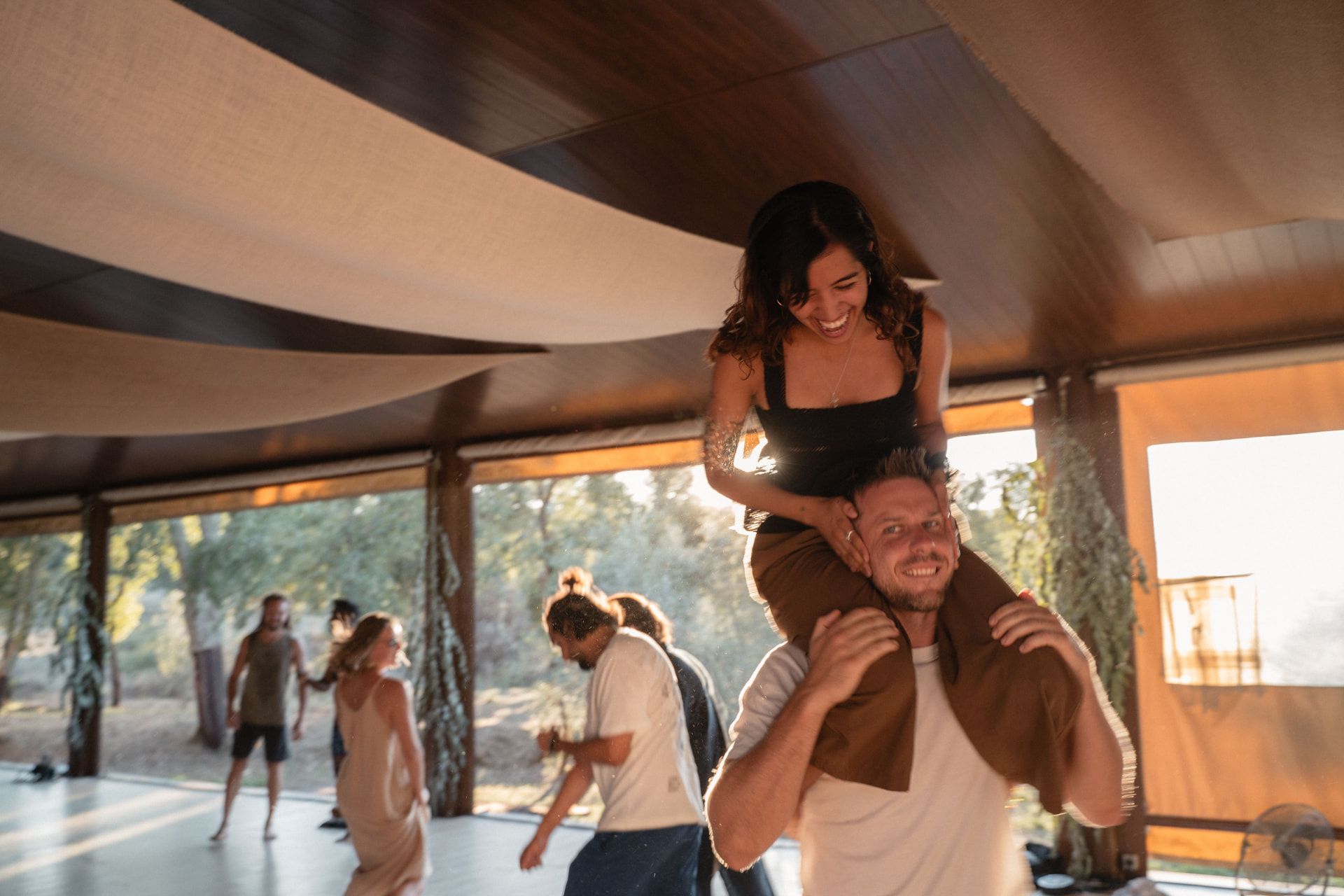 People dancing together in the hall at golden hour